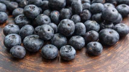 Blueberries and blueberries on the background of pottery. Black berries.