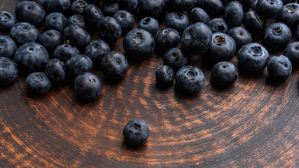 Blueberries and blueberries on the background of pottery. Black berries.