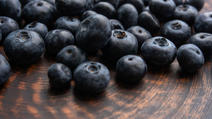 Blueberries and blueberries on the background of pottery. Black berries.