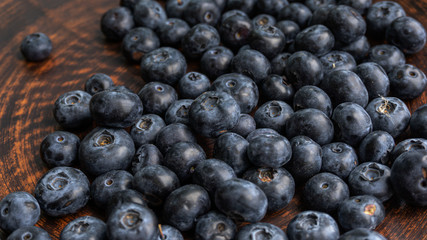 Blueberries and blueberries on the background of pottery. Black berries.