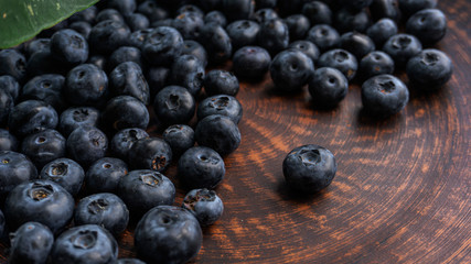Blueberries and blueberries on the background of pottery. Black berries.