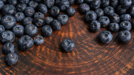 Blueberries and blueberries on the background of pottery. Black berries.