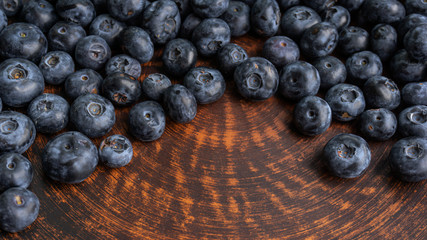 Blueberries and blueberries on the background of pottery. Black berries.