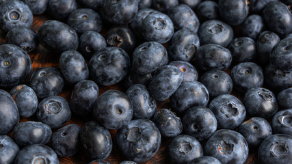 Blueberries and blueberries on the background of pottery. Black berries.