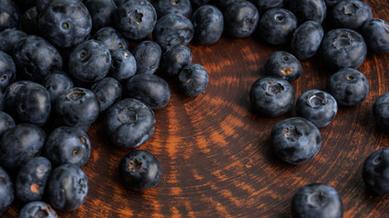 Blueberries and blueberries on the background of pottery. Black berries.