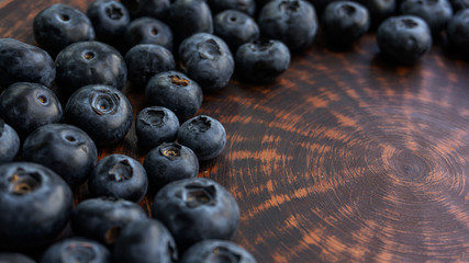 Blueberries and blueberries on the background of pottery. Black berries.