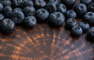 Blueberries and blueberries on the background of pottery. Black berries.