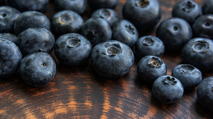 Blueberries and blueberries on the background of pottery. Black berries.