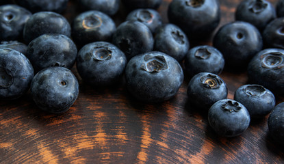 Blueberries and blueberries on the background of pottery. Black berries.