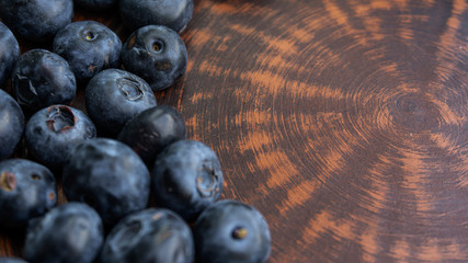Blueberries and blueberries on the background of pottery. Black berries.