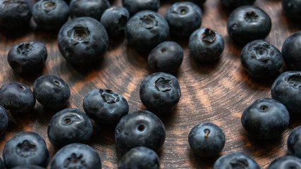 Blueberries and blueberries on the background of pottery. Black berries.