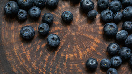 Blueberries and blueberries on the background of pottery. Black berries.