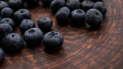Blueberries and blueberries on the background of pottery. Black berries.
