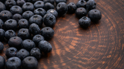 Blueberries and blueberries on the background of pottery. Black berries.