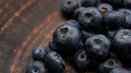 Blueberries and blueberries on the background of pottery. Black berries.