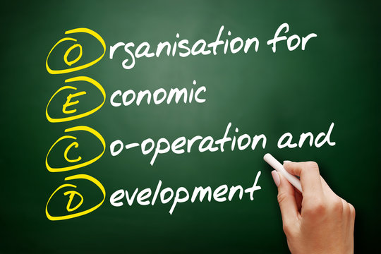 OECD - Organisation for Economic Co-operation and Development acronym, business concept on blackboard