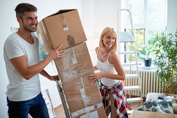 .Young man and woman moving into a new home..