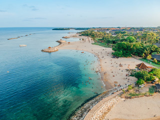 Aerial drone view of Holiday In Sanur Beach, Bali, Indonesia with ocean, boats, beach, villas, and...
