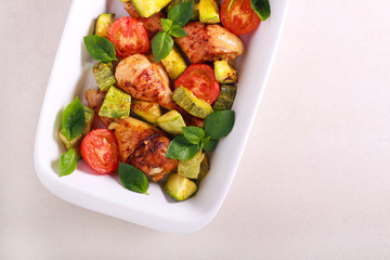Chicken drumsticks, zucchini and tomato bake