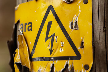 Damaged yellow warning sign