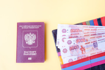 Fototapeta premium Russian five thousandth bills and passport close up and on a yellow background, top view
