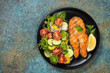 Grilled salmon fish steak with vegetables.