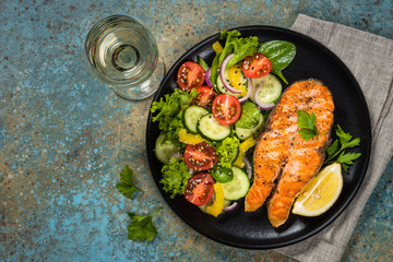 Grilled salmon fish steak with vegetables.