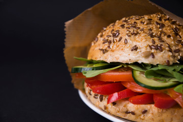 Veggie burger with tomatoes, arugula and paprika,