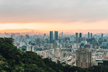 Fototapeta na wymiar Aerial view over Downtown Taipei with layers of mountain in background in the dusk from Xiangshan Elephant Mountain in the evening.