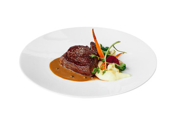 Isolated Wagyu Striploin with mashed truffle garlic confit, seasonal vegetables and red wine sauce.