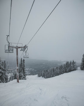 A ski lift approaching the top of the hill