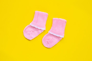 Baby socks on yellow background.