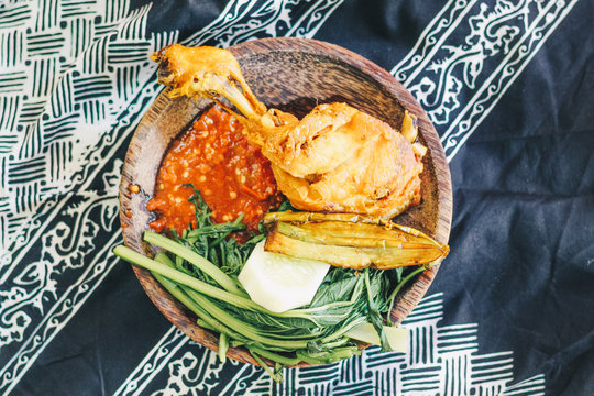 Nasi Tempong or Sego Tempong, traditional spicy culinary food of Banyuwangi, East Java, Indonesia. Similar with pecel but more spicy. mixed from rice, sambal chilli, vegetable, tofu, tempeh, and side 