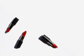 Obraz premium Flat lay composition, Lipsticks on white background with shadow. Beautiful Make-up concept