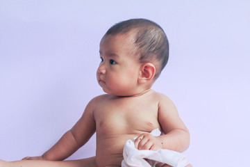 portrait of asian baby girl sitting on white background