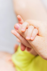 Baby fingers in mom's hands