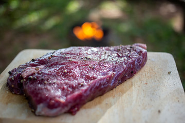 Raw beef steak with seasoning such as salt and black pepper on wood plate for grill. Homemade cooking beef steak local style recipe's.
