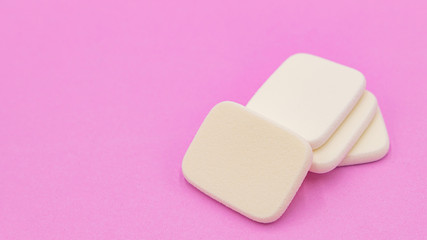 Cosmetic sponges powder for face make up on, Cosmetic sponges on pink background,