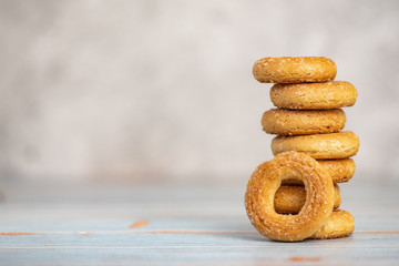 Stack of small sweet bagels on light background. With copy space