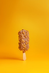 chocolate ice cream popsicle on yellow background