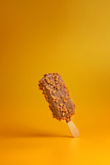 chocolate ice cream popsicle on yellow background