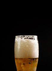 beer in glass on black background