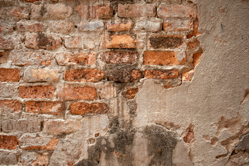 The background of the old wall was destroyed, built from red bricks.