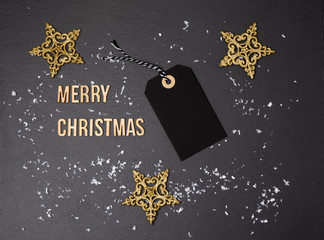 Fototapeta na wymiar Merry Christmas black background and price label. Black Friday. Sales concept. Copy space. Black paper label against a dark grey background. Black Friday shopping sale concept with Black ticket Sale