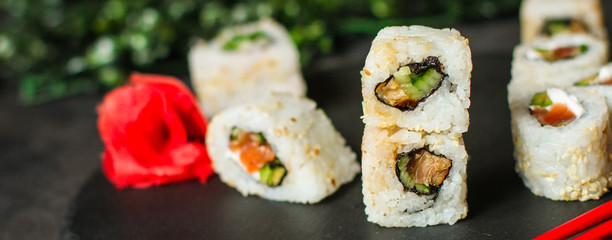 Sushi maki rolls (tuna, salmon, shrimp, avocado and other ingredients). japanese food. Top view, assorted sushi, menu. copy space