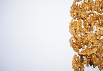 peeled walnuts on white background with free space left