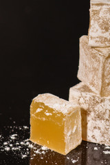 Turkish delight, sweets on a black background (dessert sweets) lokum. food background. top view. copy space