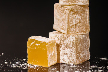 Turkish delight, sweets on a black background (dessert sweets) lokum. food background. top view. copy space