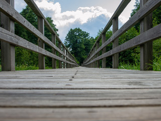 Picture of a wooden bridge with a beautiful lake and clouds, Latvia