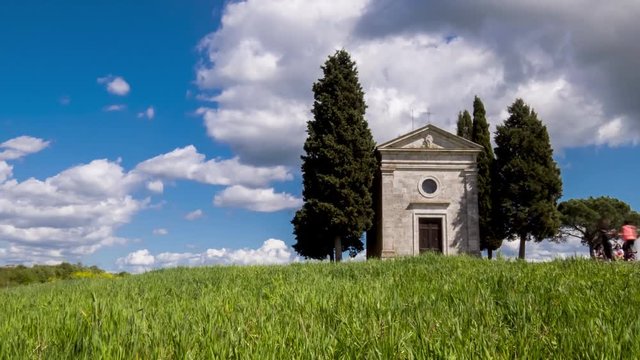 Siena 2019. Time Lapse of the Madonna di Vitaleta Chapel, San Quirico D'Orcia. The small church is surrounded by the cypress trees of Chianti and by many tourists intent on taking photos and selfies. 
